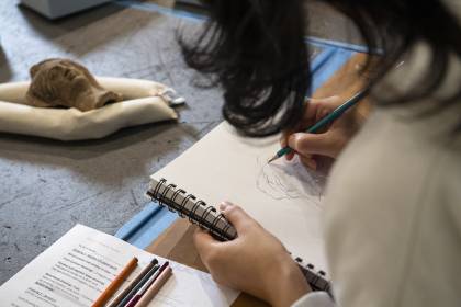 Students drawing in archeological museum